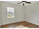 Simple bedroom with wood flooring and a window at 2116 Sarah Way, Mulberry, FL 33860