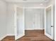 Bright interior room with hardwood floors and white doors at 2116 Sarah Way, Mulberry, FL 33860