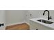 Laundry room with white cabinets and a clean sink at 2116 Sarah Way, Mulberry, FL 33860