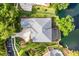 Aerial view of house, showcasing the roofline, landscaping, pool, and location on a lake at 5933 Lake Victoria Dr, Lakeland, FL 33813
