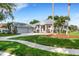 House exterior showcasing a two-car garage, manicured lawn, and walkway at 5933 Lake Victoria Dr, Lakeland, FL 33813