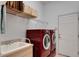 Laundry room with washer, dryer, utility sink, and overhead storage at 5933 Lake Victoria Dr, Lakeland, FL 33813