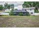 View of the home's backyard with a large screened in patio, and partial lawn at 1305 Avenue S Nw, Winter Haven, FL 33881
