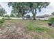 Large backyard featuring a wooden shed, some trees, and a fence at 1305 Avenue S Nw, Winter Haven, FL 33881