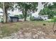 Spacious backyard with mature trees, shed, and privacy fence at 1305 Avenue S Nw, Winter Haven, FL 33881