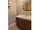 Bathroom with brown vanity and a tiled shower/tub combo at 1305 Avenue S Nw, Winter Haven, FL 33881