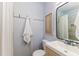 Bathroom with modern vanity, mirror, and shower with marble tile at 1305 Avenue S Nw, Winter Haven, FL 33881