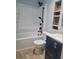 Updated bathroom with a tub, shower, and navy vanity at 1305 Avenue S Nw, Winter Haven, FL 33881