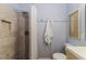 Well-lit bathroom with a shower and tub combination, towel rack, and decorative art at 1305 Avenue S Nw, Winter Haven, FL 33881