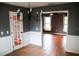Dining room with gray walls, white wainscoting and view into kitchen at 1305 Avenue S Nw, Winter Haven, FL 33881