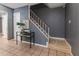 Entryway featuring tile floors, stairs to the left, decorative table with books and art, and gray walls at 1305 Avenue S Nw, Winter Haven, FL 33881