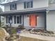 Two-story house with gray painted brick, a coral door and landscaping at 1305 Avenue S Nw, Winter Haven, FL 33881