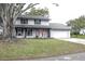 Two-story house with gray painted brick and a large tree in the front yard at 1305 Avenue S Nw, Winter Haven, FL 33881