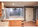 Kitchen with light wood cabinets and tile flooring at 1305 Avenue S Nw, Winter Haven, FL 33881