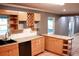 Kitchen boasts wood cabinets and tile countertops at 1305 Avenue S Nw, Winter Haven, FL 33881
