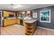 Bright kitchen with tile floors, wood cabinets, modern appliances, and an island at 1305 Avenue S Nw, Winter Haven, FL 33881
