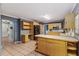 Open kitchen featuring tile countertops and floors, wooden cabinets, and black appliances at 1305 Avenue S Nw, Winter Haven, FL 33881