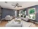 Bright living room featuring neutral-toned furniture, an accent wall, and a view to the front yard at 1305 Avenue S Nw, Winter Haven, FL 33881