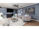 Comfortable living room with stylish seating, a large TV, and an open doorway to the next room at 1305 Avenue S Nw, Winter Haven, FL 33881