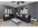 Stylish living room with dark grey walls, contemporary furniture, and neutral rug at 1305 Avenue S Nw, Winter Haven, FL 33881