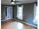 Spacious living room with tile floors and two windows at 1305 Avenue S Nw, Winter Haven, FL 33881