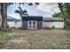Backyard featuring a shed with double doors, situated in a yard with a fence surround at 1305 Avenue S Nw, Winter Haven, FL 33881