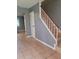 Gray walls and beige tile flooring with a wooden staircase at 1305 Avenue S Nw, Winter Haven, FL 33881