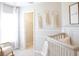 Serene Bedroom showcasing a crib, closet, and calming decorations for a nurturing environment at 1839 Daystar Dr, Haines City, FL 33844