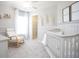 Charming Bedroom featuring a crib, rocking chair, and soft decor for a peaceful atmosphere at 1839 Daystar Dr, Haines City, FL 33844