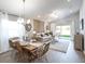 Open-concept living and dining area with bright natural light and modern furnishings at 1839 Daystar Dr, Haines City, FL 33844