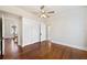 Bright bedroom with hardwood floors, ceiling fan, and closet space with an ensuite bathroom at 311 E Belmar St, Lakeland, FL 33803