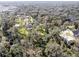 Aerial view of a home nestled among mature trees on a spacious lot at 3940 Laurel Branch Dr, Lakeland, FL 33810