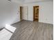 Bright bedroom with grey vinyl plank flooring and access to bathroom at 3940 Laurel Branch Dr, Lakeland, FL 33810