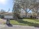 House exterior featuring a two-car garage and a well-manicured lawn at 3940 Laurel Branch Dr, Lakeland, FL 33810