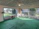 Florida room with green carpeting, white lattice ceiling, and view of backyard at 3940 Laurel Branch Dr, Lakeland, FL 33810