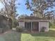 Small guest house with screened porch and mature landscaping at 3940 Laurel Branch Dr, Lakeland, FL 33810