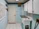 Laundry room with utility sink, cabinets, and tiled floor at 3940 Laurel Branch Dr, Lakeland, FL 33810