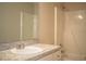 Bathroom featuring a sink and vanity combo and shower and tub with white tile surround at 5058 Cimarron Dr, Lakeland, FL 33813