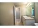Spacious bathroom featuring a vanity with a large mirror and a door to a separate room at 5058 Cimarron Dr, Lakeland, FL 33813
