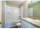 Bathroom featuring a sink and vanity combo and shower and tub with white tile surround at 5058 Cimarron Dr, Lakeland, FL 33813