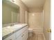 Bathroom featuring a sink and vanity combo and shower and tub with white tile surround at 5058 Cimarron Dr, Lakeland, FL 33813