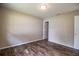 Bedroom featuring wood flooring and a neutral color scheme at 5058 Cimarron Dr, Lakeland, FL 33813