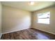 A standard bedroom with hardwood floors and a window letting in natural light at 5058 Cimarron Dr, Lakeland, FL 33813