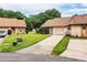 Well-maintained single-story home with an attached garage, long driveway, and green lawn with minimal landscaping at 5058 Cimarron Dr, Lakeland, FL 33813