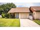 Charming single-story home featuring an attached garage, well-maintained lawn, and simple landscaping at 5058 Cimarron Dr, Lakeland, FL 33813