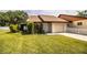 Inviting single-story home with a well-maintained lawn and landscaping at 5058 Cimarron Dr, Lakeland, FL 33813