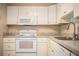Updated kitchen featuring white cabinetry, modern appliances, and a stainless steel sink at 5058 Cimarron Dr, Lakeland, FL 33813