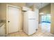 Bright kitchen featuring tile floors, a white refrigerator, and access to a screened-in lanai at 5058 Cimarron Dr, Lakeland, FL 33813