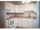 Clean kitchen with white cabinets, modern appliances, and a stylish countertop at 5058 Cimarron Dr, Lakeland, FL 33813