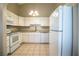 Well-equipped kitchen featuring white cabinets, a modern microwave, and stainless steel appliances at 5058 Cimarron Dr, Lakeland, FL 33813